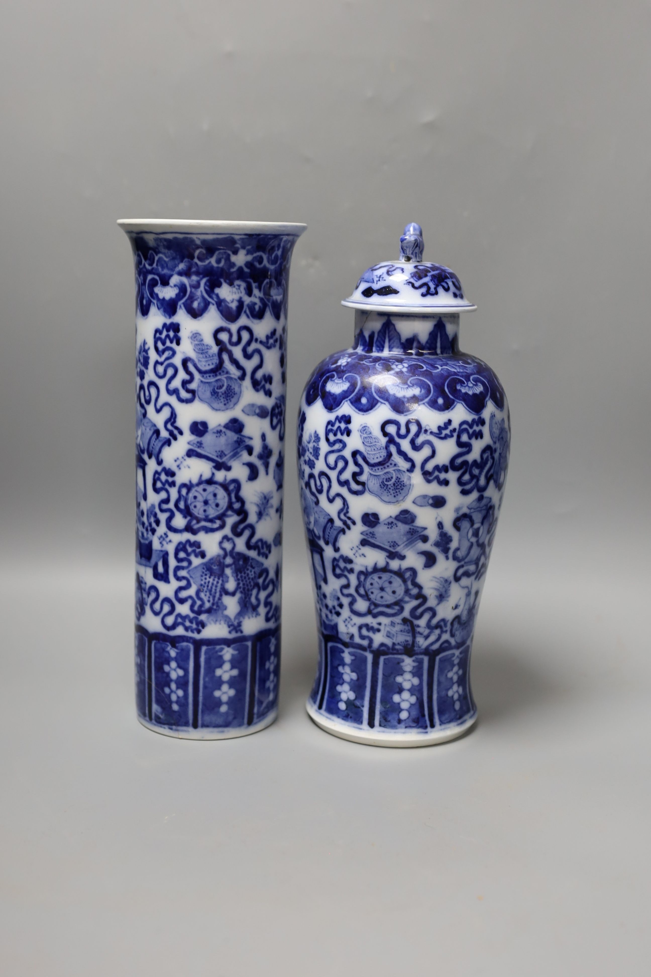 A Continental blue and white sleeve vase and a vase and cover (a.f.) 30.5cm